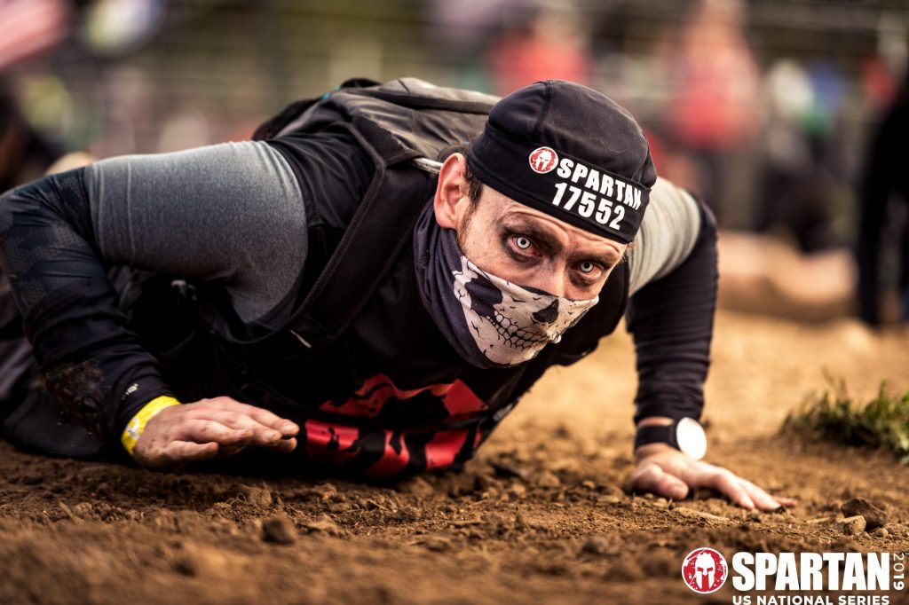 joshua-marron-spartan02 - the level up arena - health fitness coaching Joshua Marron crawling under barbwire at a Spartan Race