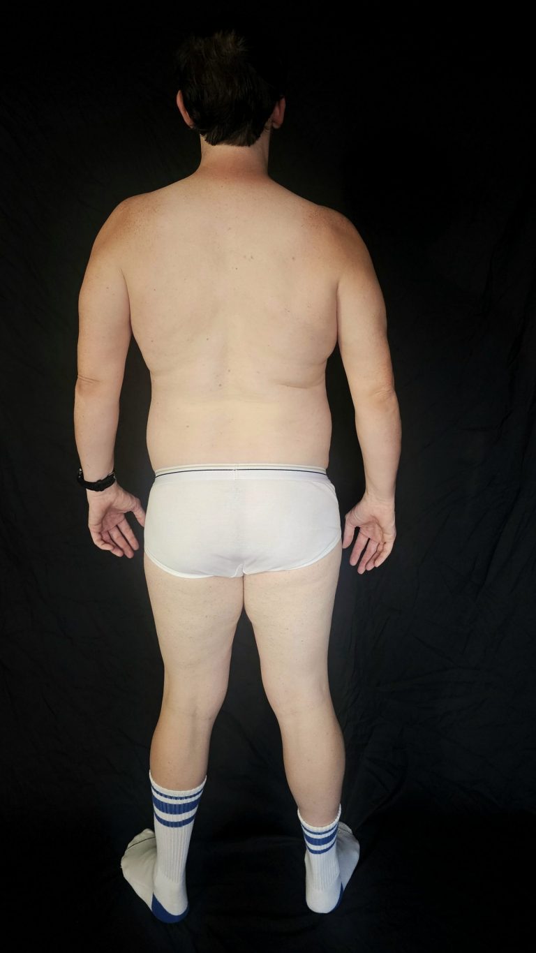 Back view progress photo of Joshua Marron in white briefs and socks, showing body composition update after completing Week 1 of Project Legacy.