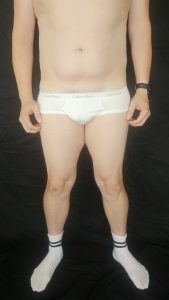 Close-up of Joshua Marron’s lower abs and thighs in white briefs for Project Legacy vegan body transformation tracking.