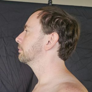 Close-up side profile photo of Joshua Marron facing left, for Project Legacy vegan fitness progress photos.