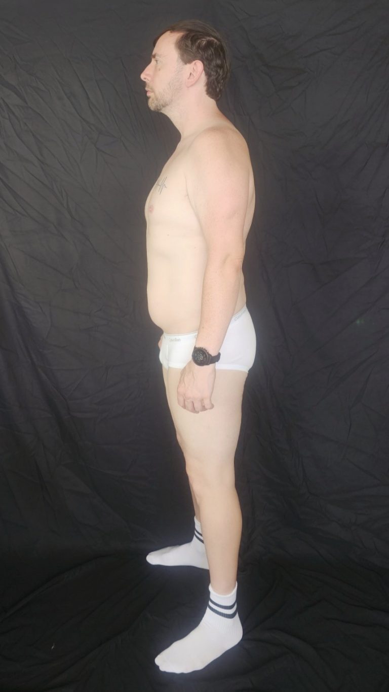 Joshua Marron standing in left side profile view in white briefs and socks for Project Legacy body transformation progress photo.