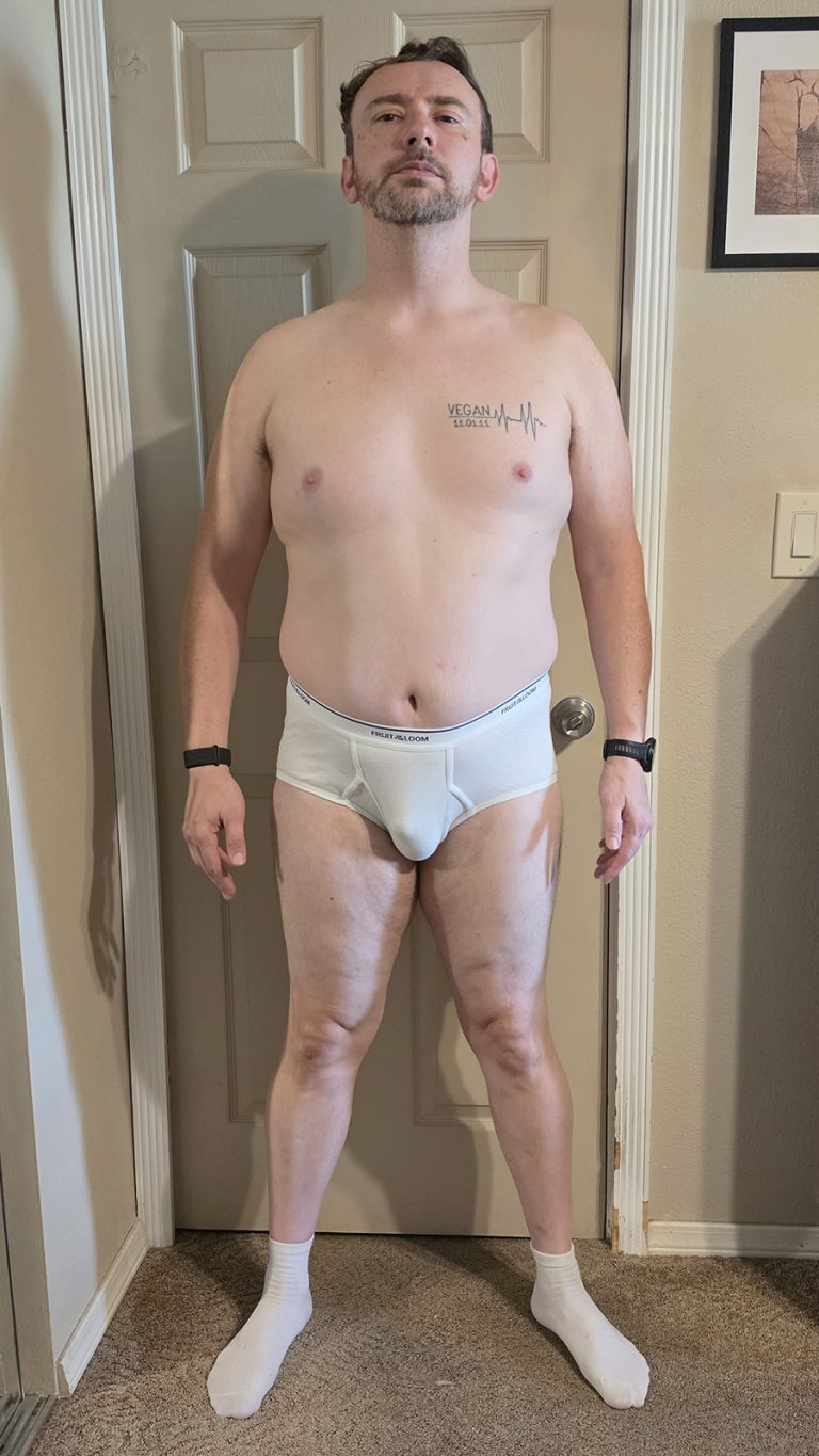 Week 1 progress photo of Joshua Marron in white briefs and socks, standing in a Front pose for the Resurgam transformation.